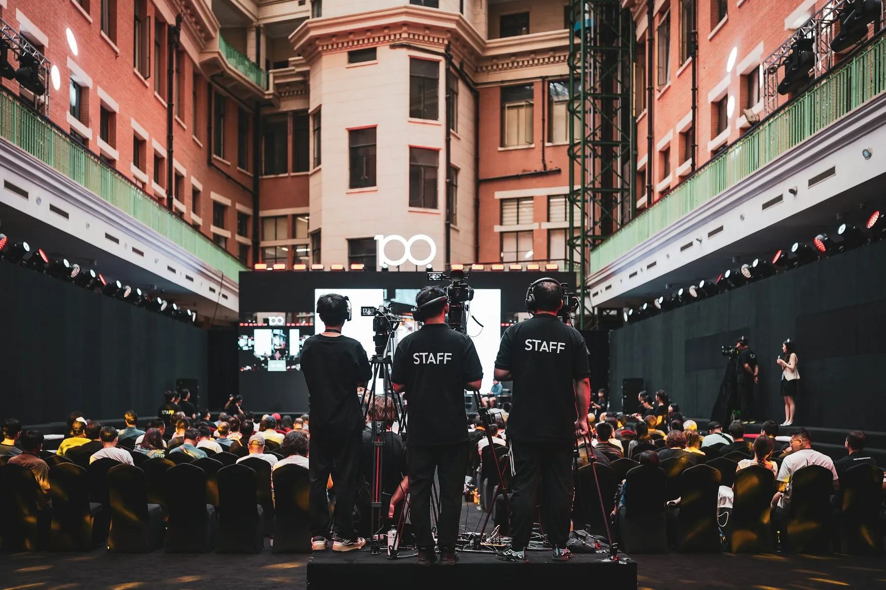 Event crew and an audience during a live event in a Shanghai atrium